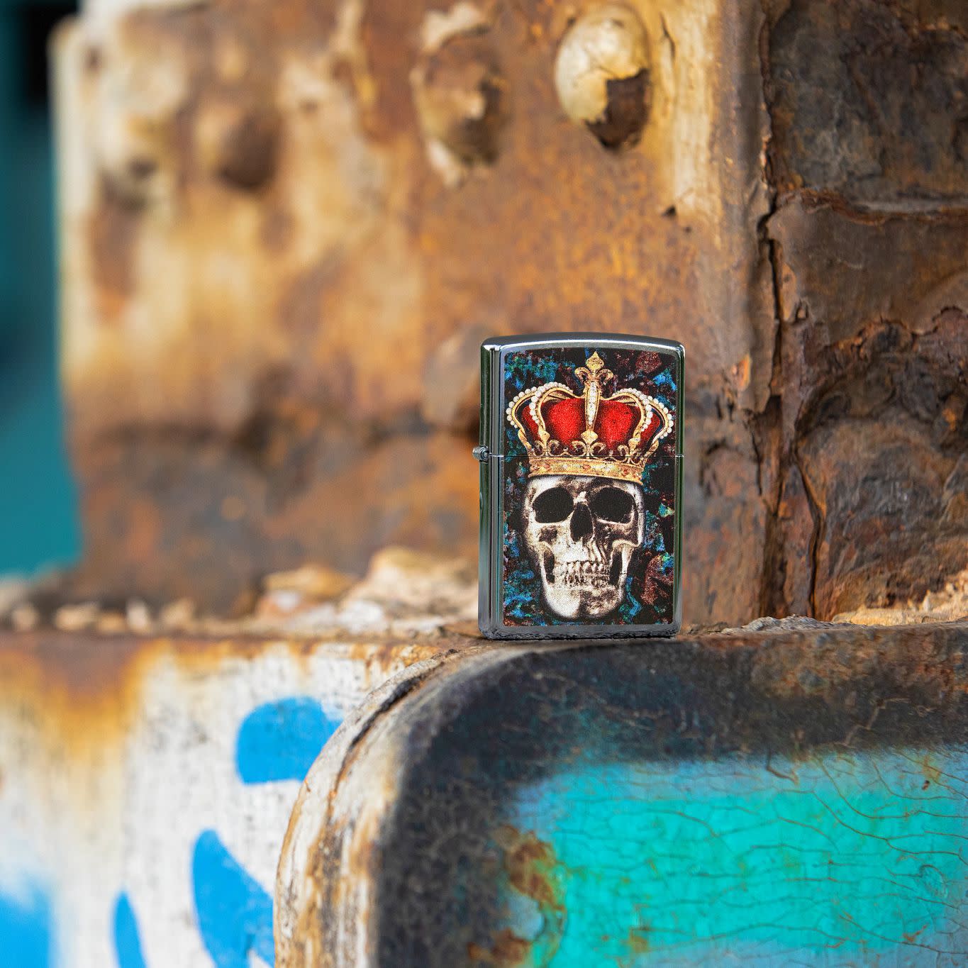 Lifestyle image of Skull King Design Street Chrome?äó Windproof Lighter standing in a graffiti scene.